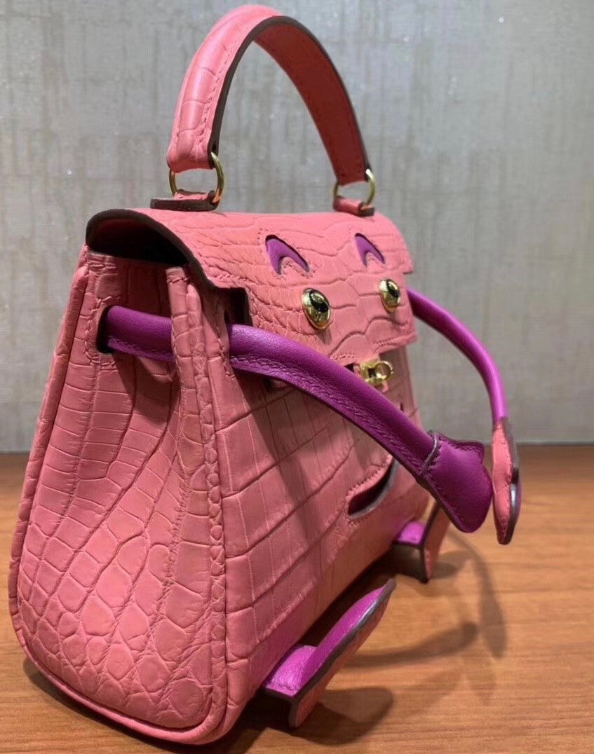 Hermes Kelly Idole (Kelly Doll) in Pink Sakura  Nilo crocodile with Palladium hardware.