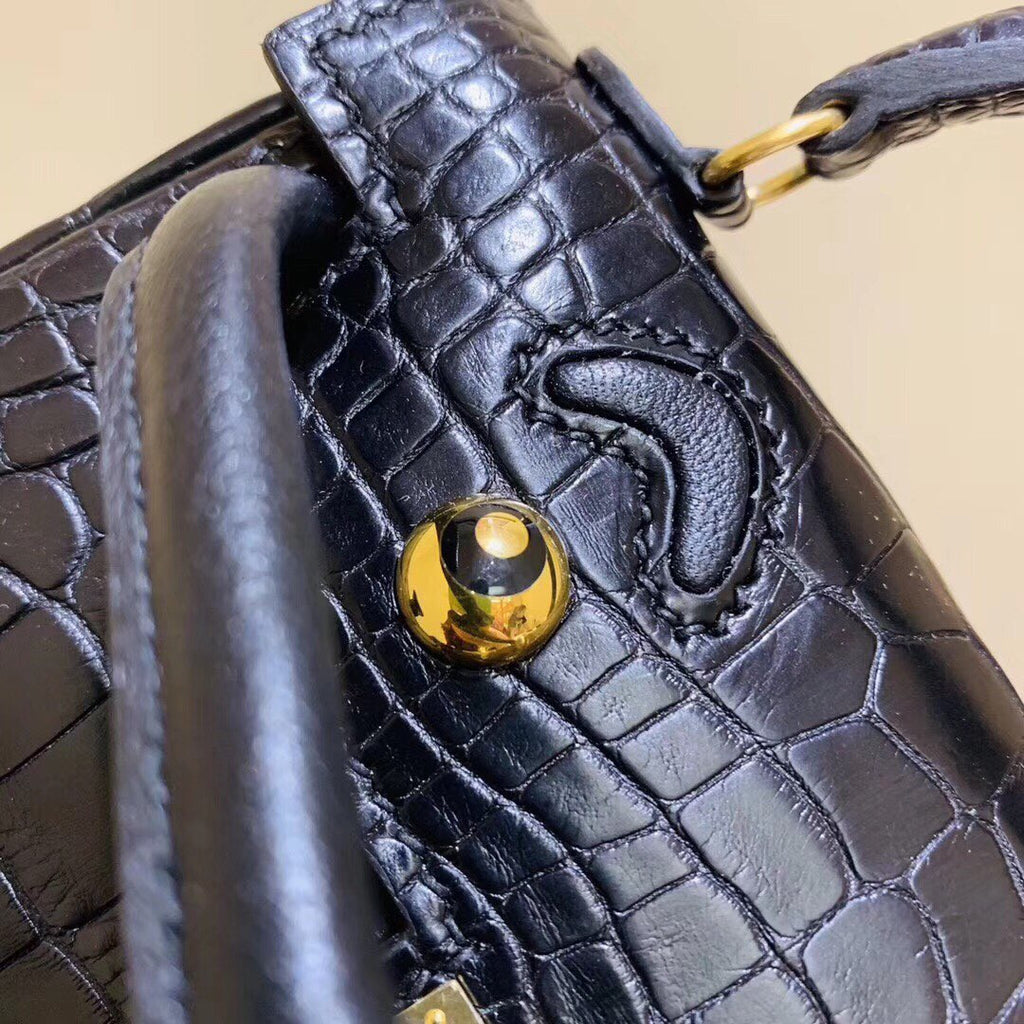 Hermes Kelly Idole (Kelly Doll) in Black Alligator with Gold hardware.