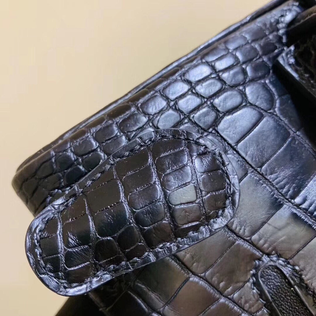 Hermes Kelly Idole (Kelly Doll) in Black Alligator with Gold hardware.