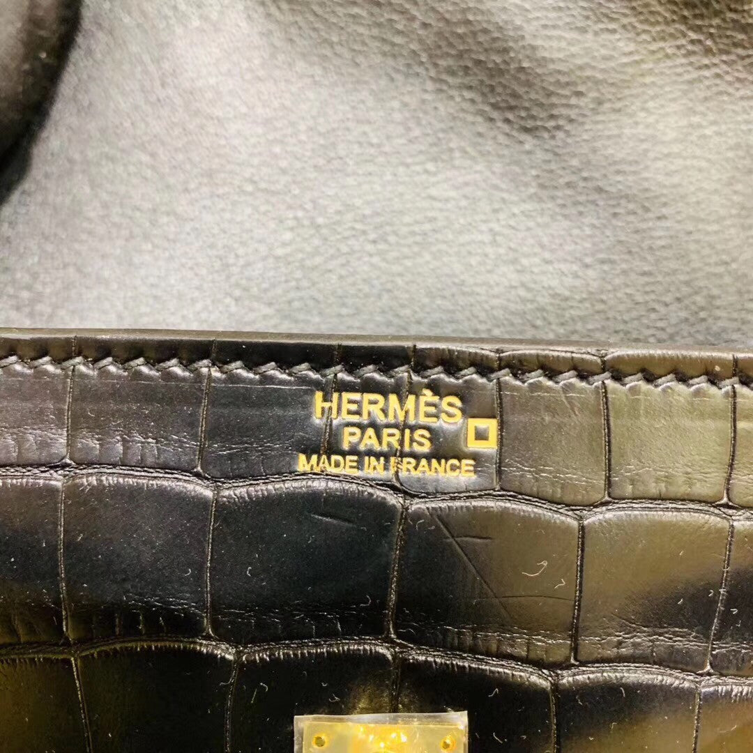 Hermes Kelly Idole (Kelly Doll) in Black Alligator with Gold hardware.