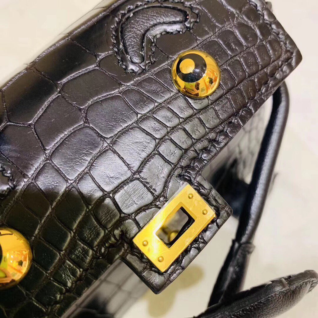Hermes Kelly Idole (Kelly Doll) in Black Alligator with Gold hardware.