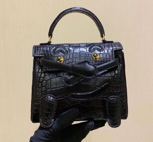Hermes Kelly Idole (Kelly Doll) in Black Alligator with Gold hardware.