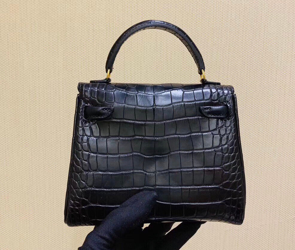 Hermes Kelly Idole (Kelly Doll) in Black Alligator with Gold hardware.