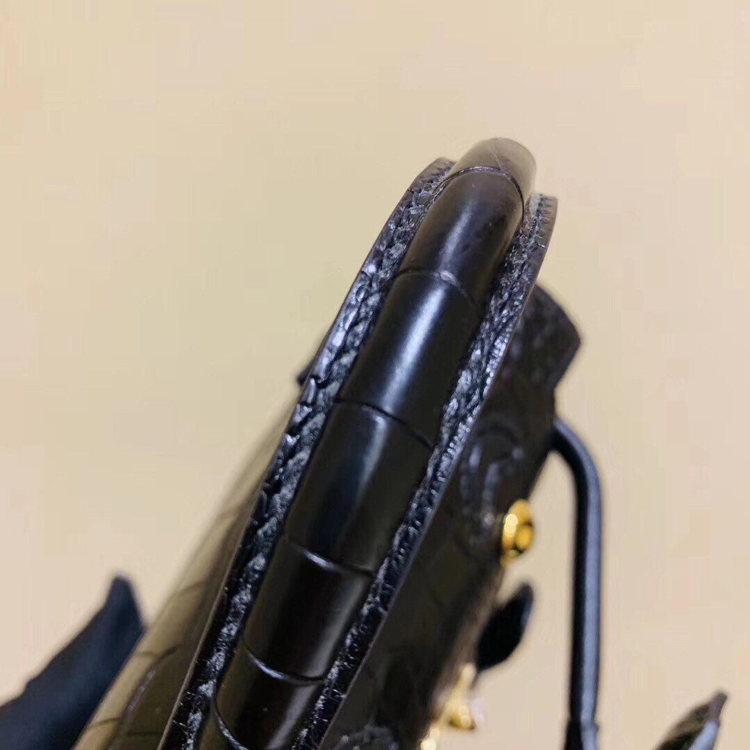 Hermes Kelly Idole (Kelly Doll) in Black Alligator with Gold hardware.