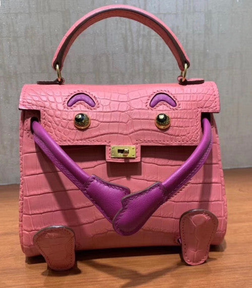 Hermes Kelly Idole (Kelly Doll) in Pink Sakura  Nilo crocodile with Palladium hardware.