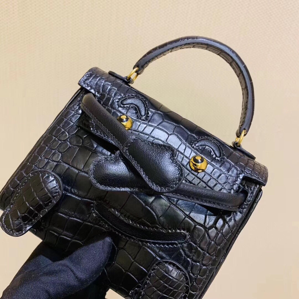 Hermes Kelly Idole (Kelly Doll) in Black Alligator with Gold hardware.