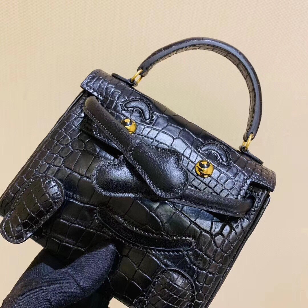 Hermes Kelly Idole (Kelly Doll) in Black Alligator with Gold hardware.