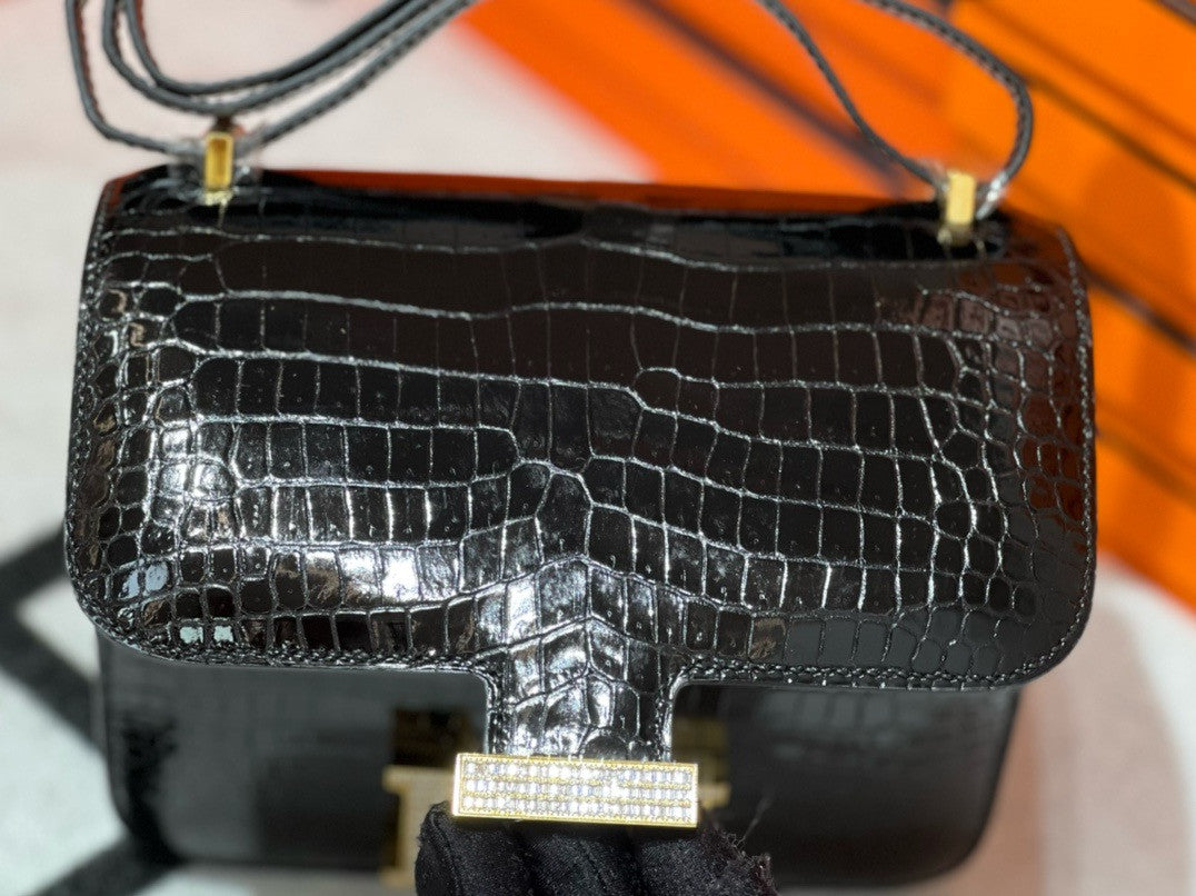 HERMES SHINY BLACK POROSUS CROCODILE MINI CONSTANCE 18 WITH GOLD & DIAMOND HARDWARE
