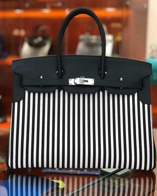 HERMES A LIMITED EDITION BLACK SWIFT LEATHER & TOILE RIGA BIRKIN 35 WITH PALLADIUM HARWARE