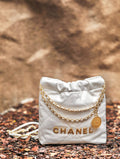 CHANEL 22 MINI HANDBAG GOLD LOGO SS2023 WHITE