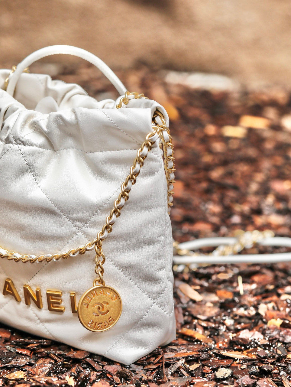 CHANEL 22 MINI HANDBAG GOLD LOGO SS2023 WHITE