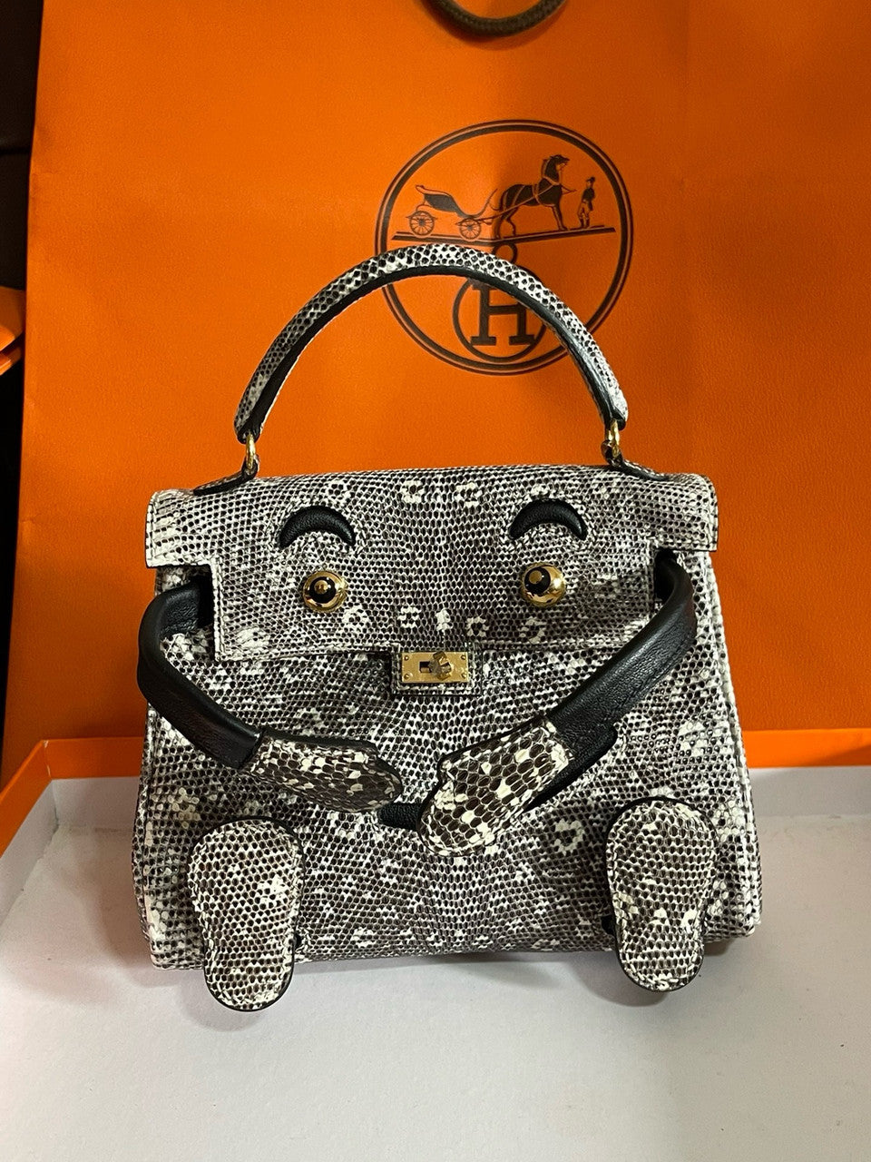 Hermes Kelly Idole (Kelly Doll) in Lizard with Gold hardware.