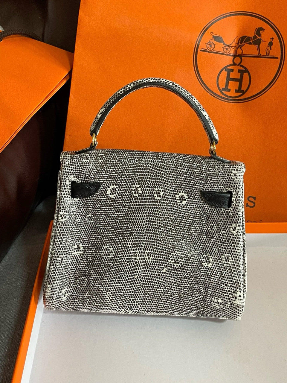Hermes Kelly Idole (Kelly Doll) in Lizard with Gold hardware.